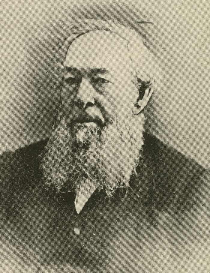 Black and white photograph of a man with large white beard