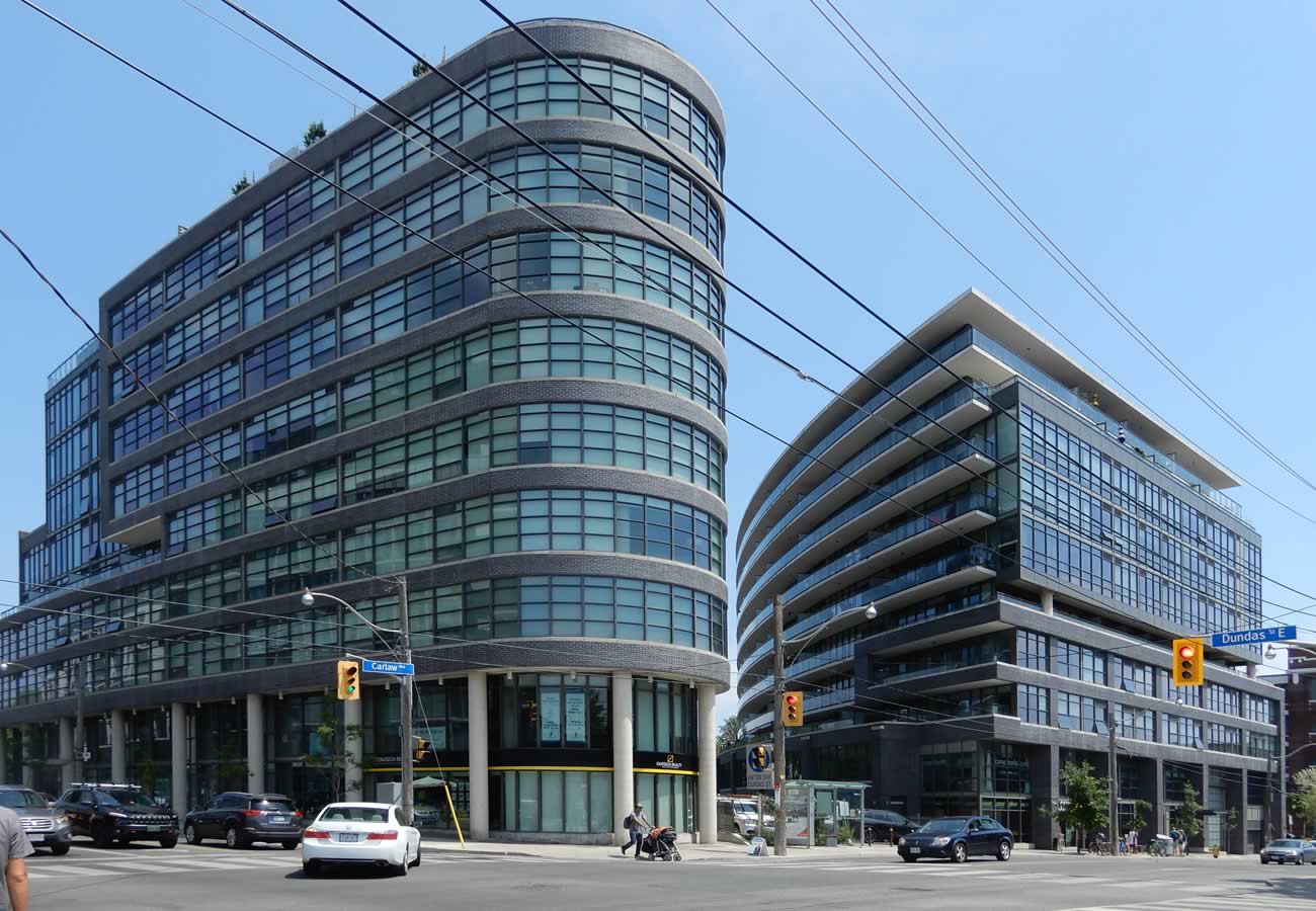 Colour photograph of two curved modern glass condos with distinctive curved shapes.