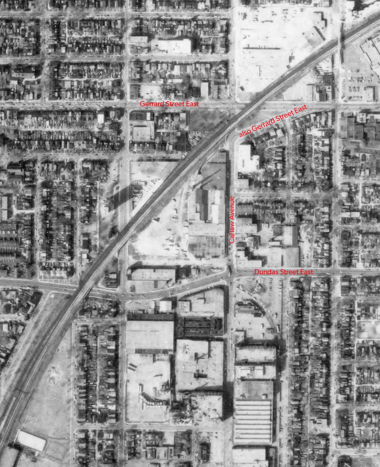 Aerial map of the Dundas and Carlaw neighbourhood with street names in red, showing the two paths taken by Gerrard Street East when standing at 369 Carlaw Avenue.