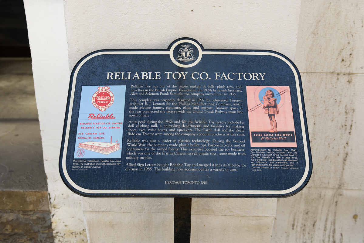 Plaque for The Reliable Toy Co. Factory. Featuring two images promoting the factory. One of the images is an advertisement for the Reliable brand doll and the other image is an advertisement featuring the factory building.
